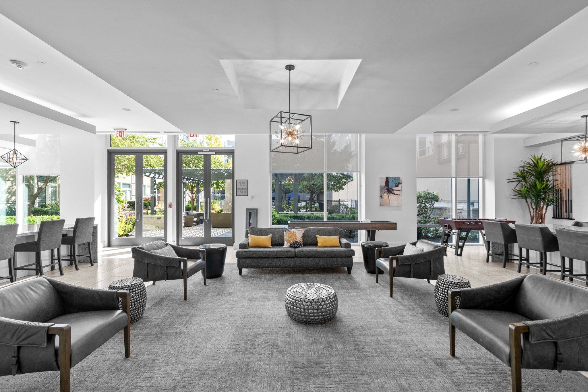 a large living room with couches and chairs and a table and chairs in front